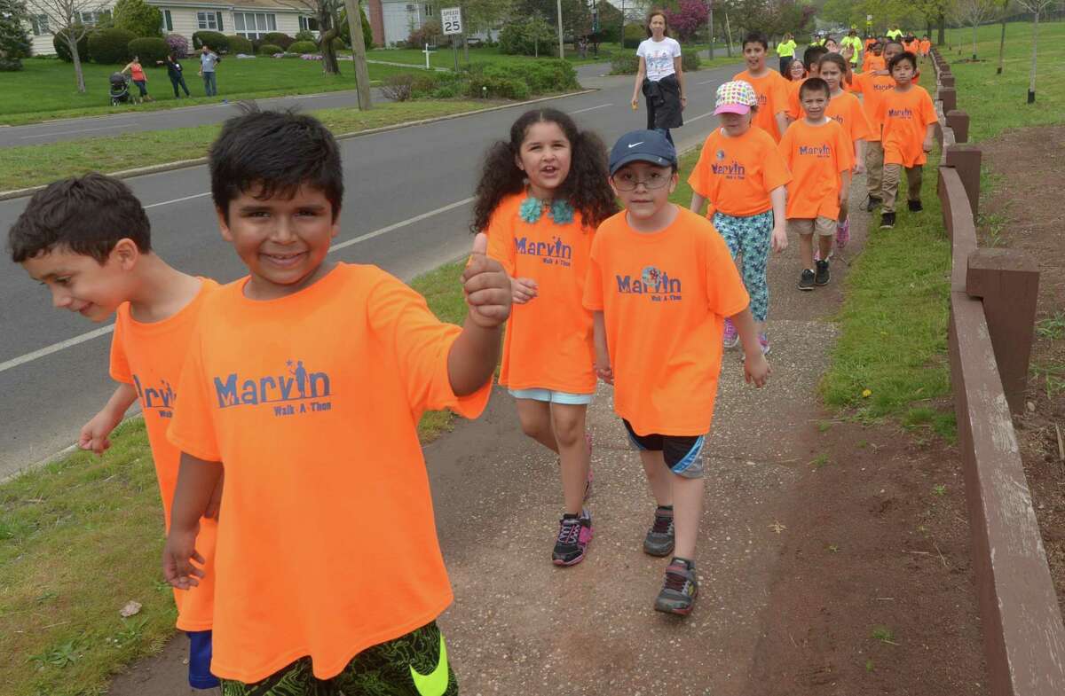 Marvin Elementary School students participate in the school's walk-a-thon Friday, May 4, 2018, down Beach Road and around Shady Beach in Norwalk, Conn. Events like these require special permits from the city, which is installing a new software program to make it easier for organizers to get permits.