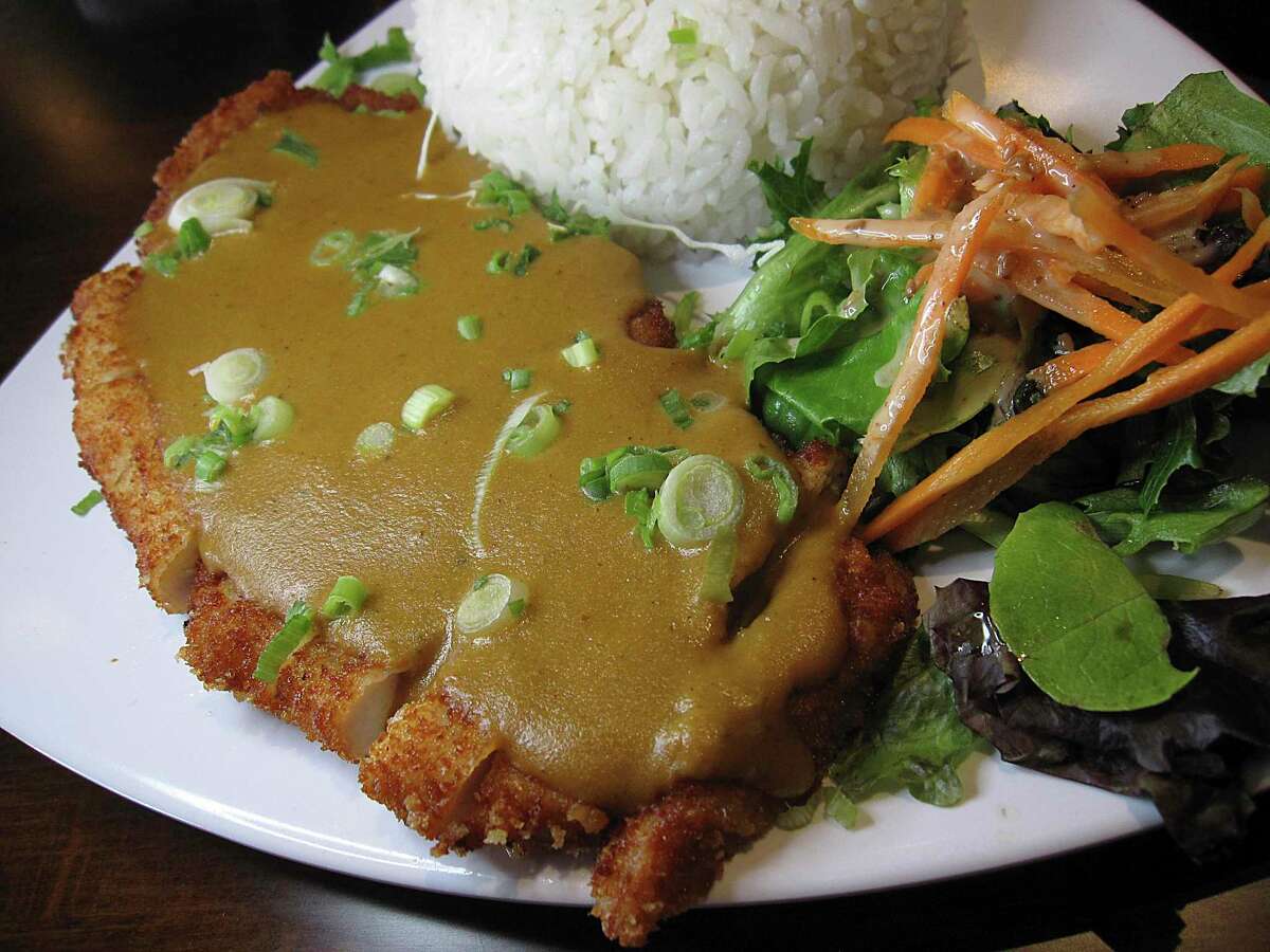 Chicken Katsu Tokyo Curry Rice is a deep-fried chicken cutlet with curry sauce, rice and salad at Bakudan Ramen.