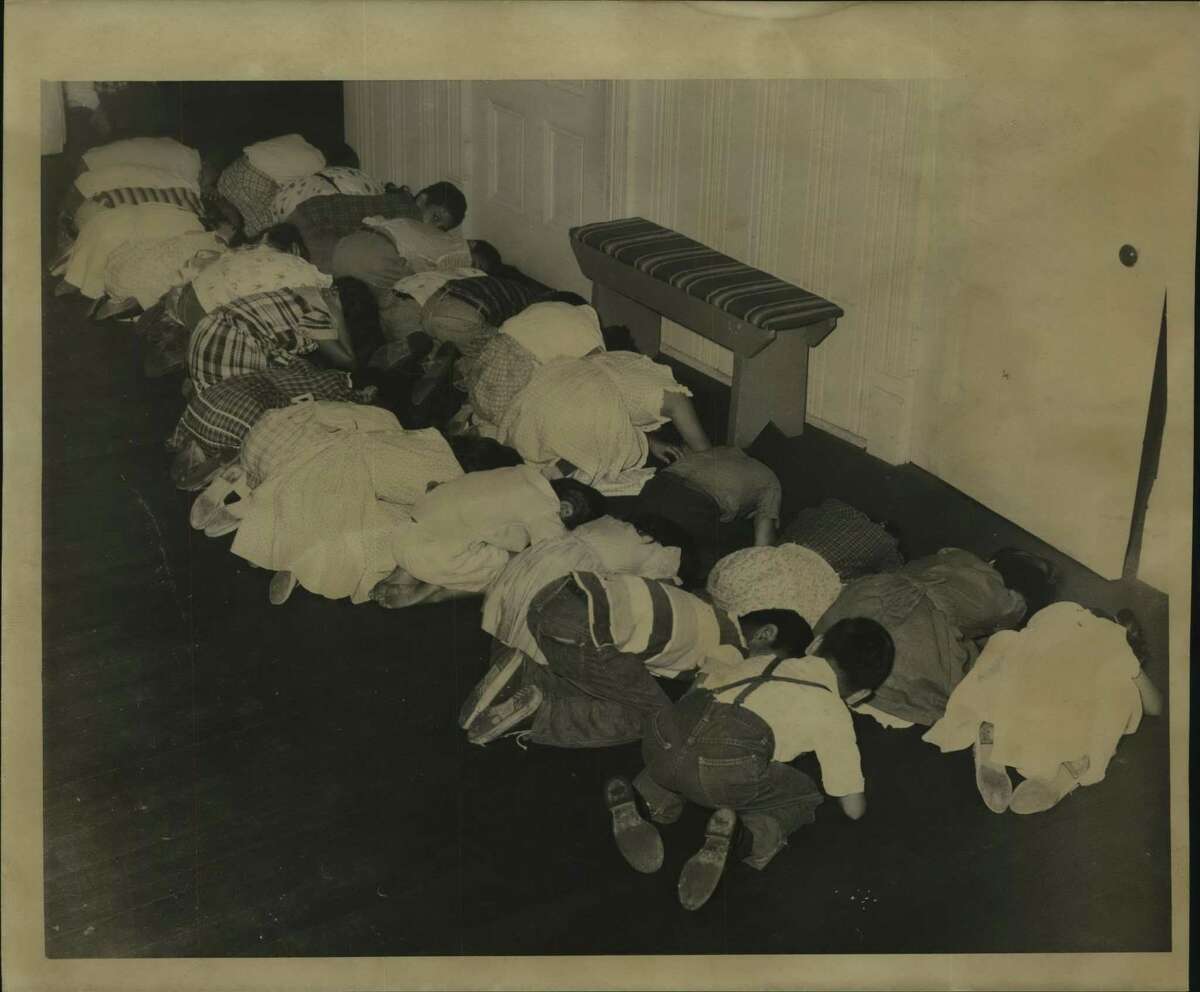 Young students prepare for disaster as they kneel on the floor and duck their heads at Jones Elementary School in Houston, Texas in this undated photo.