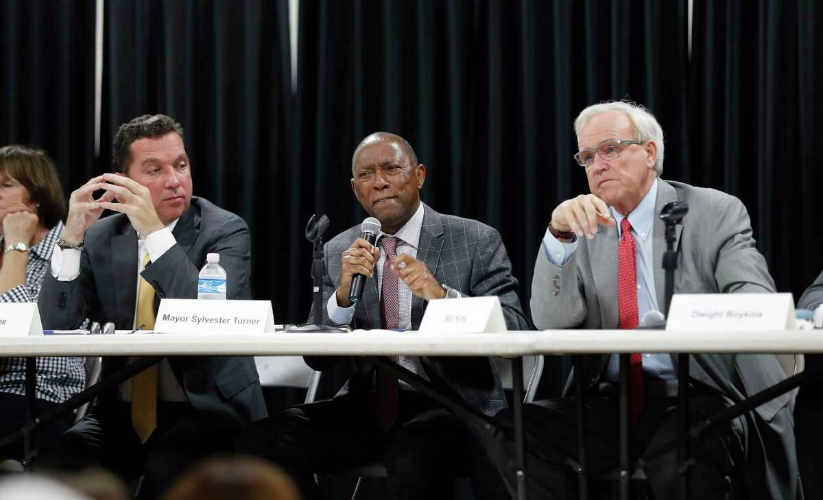 Mayor Sylvester Turner argues with Bill King as Tony Buzbee listens during a mayoral candidate forum for the 2019 election at the Garden Oaks Montessori Magnet school, September 3, 2019, in Houston. This is Mayor Sylvester Turner's first candidate forum. The forum is hosted by Super Neighborhood 12 and the Garden Oaks Civic Club.