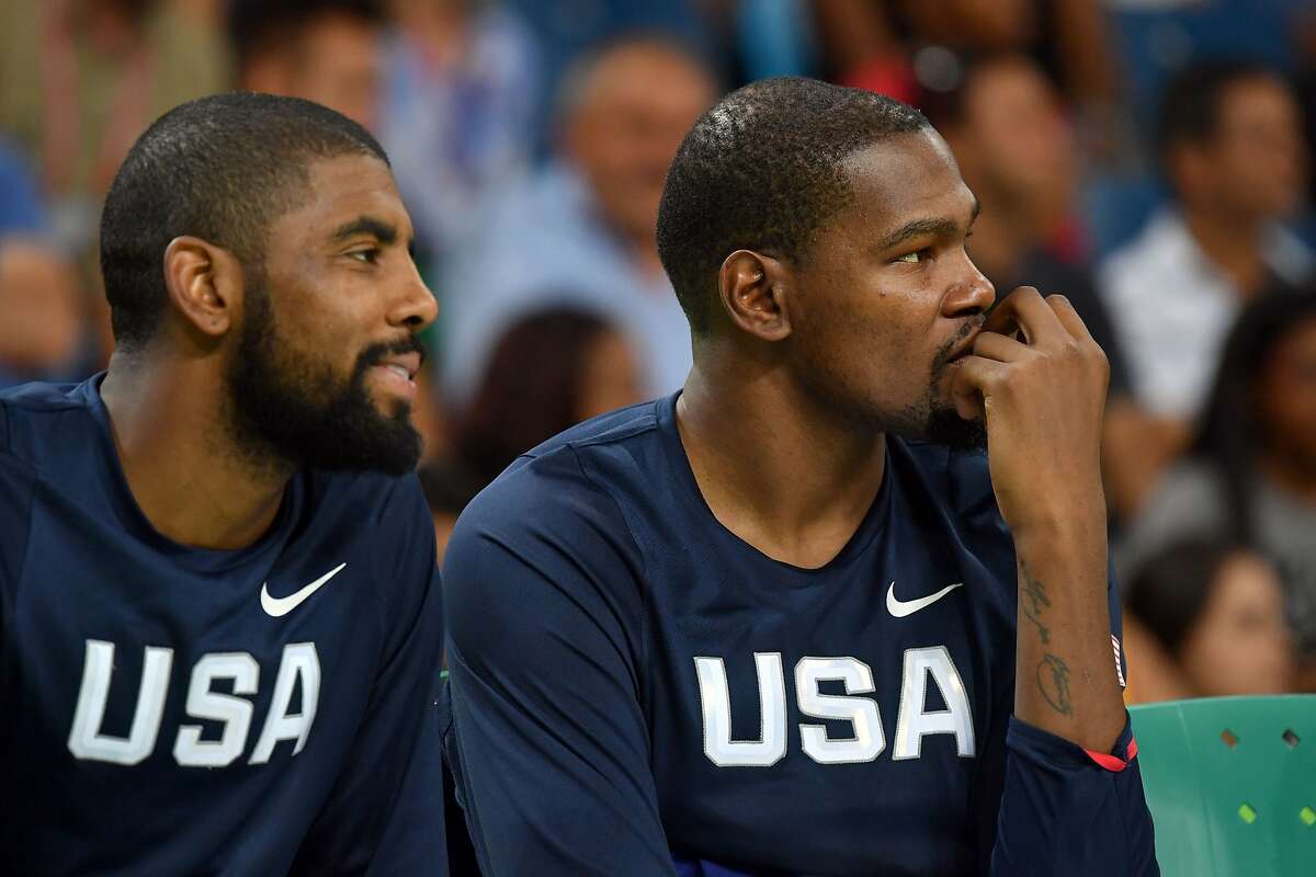 (FILES) In this file photo taken on August 06, 2016 USA's guard Kyrie Irving (L) and USA's guard Kevin Durant (R) look on from the substitutes' bench during a Men's round Group A basketball match between China and USA at the Carioca Arena 1 in Rio de Janeiro during the Rio 2016 Olympic Games. -