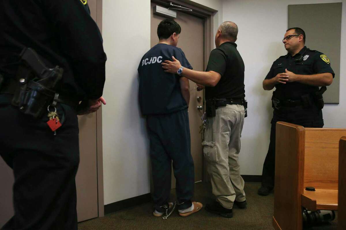 A juvenile murder suspect is led out after a detention hearing before Bexar County 289th Juvenile District Court Judge Carlos Quezada, Thursday, Sept. 26, 2019. He is suspected in the murder of his mother, Melissa Stebbins Alvarado, 50. Police responded to a call on Sept. 11 at the 500 block of General Krueger and found Alvarado dead with a gunshot to her head.