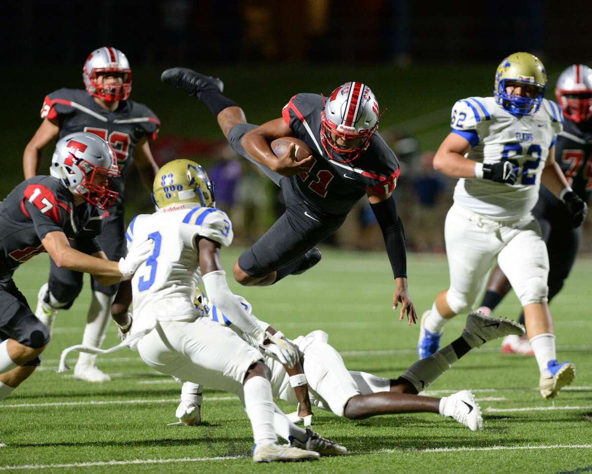 PHOTOS: Travis vs. Elkins Eric Rodriguez (11) of Travis carries the ball on a quarterback keeper during the second quarter of a 6A Region III District 20 football game between the Elkins Knights and the Travis Tigers on Thursday, September 26, 2019 at Mercer Stadium, Sugar Land, TX.