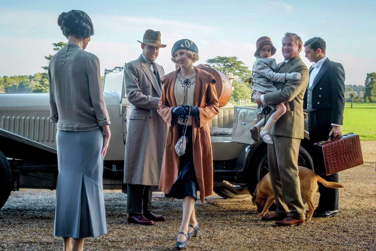 This image released by Focus Features shows Elizabeth McGovern, from left, Harry Hadden-Paton, Laura Carmichael, Hugh Bonneville and Michael Fox, right, in a scene from the film “Downton Abbey.”