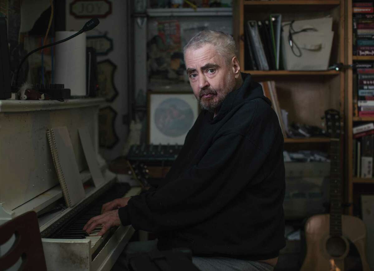 FILE -- Daniel Johnston plays piano at his home in Waller, Tex., in 2017. Johnston, a singer-songwriter and visual artist whose childlike, haunted songs brought him acclaim as one of America’s most gifted outsider voices, died on Sept. 11, 2019, at his home outside Houston. He was 58. (Bryan Schutmaat/The New York Times)