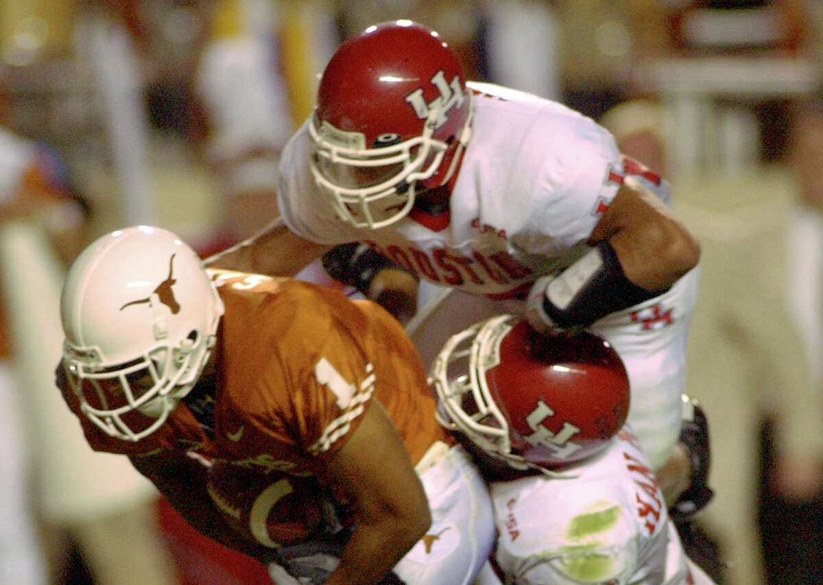 PHOTOS: UH vs. Tulane  Texas receiver Sloan Thomas drags Houston's Victor Malone (top) and Jermain Woodard towards the goal line on his way to scoring another touchdown late in the second quarter Saturday night at Darrell K. Royal - Texas Memorial Stadium in Austin, Texas. 9/21/02 Karl Stolleis/Houston Chronicle. HOUCHRON CAPTION (09/24/2002): Trying to stop Sloan Thomas was kind of a drag for UH defenders like Victor Malone, top, and Jermain Woodard as Thomas caught six passes for 87 yards and a touchdown against the Cougars. >>>See photos from the Cougars' game against Tulane last week ... 
