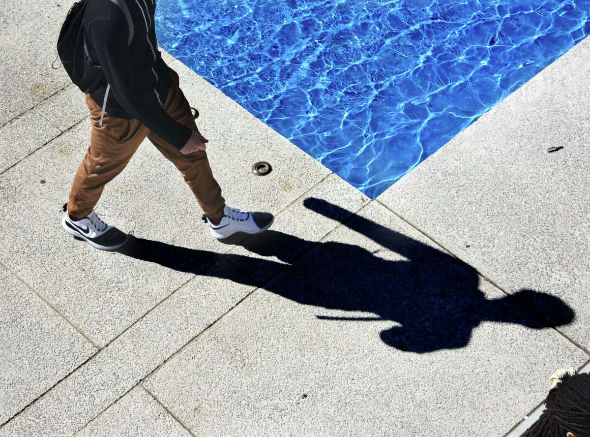 A student walks through the fountain at University at Albany Friday, Sept. 27, 2019 in Albany, N.Y. (Lori Van Buren/Times Union)