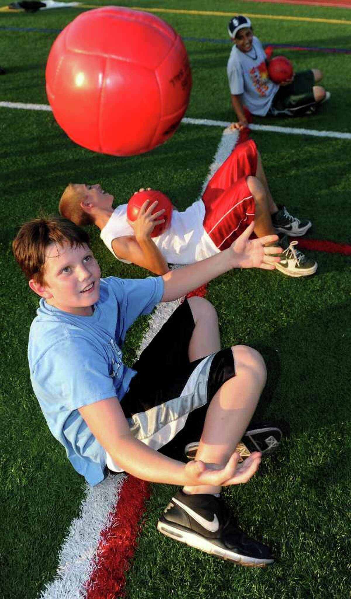 Ryan Holbrook, 11, practices a fitness drill during the Chelsea Cohen Fitness Academy Kickoff at Norwalk High School's Testa Field on Thursday, August 5, 2010.
