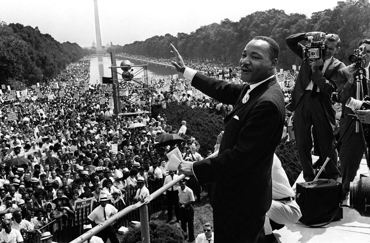 This August 28, 1963 file photo shows US civil rights leader Martin Luther King (C) waving from the steps of the Lincoln Memorial to supporters on the Mall in Washington, DC, during the "March on Washington". US President Barack Obama marks the 50th anniversary of Martin Luther King's "I have a dream" speech by speaking from the same steps at the Lincoln Memorial in Washington August 28, 2013. Obama, the first black US president, spoke about the half century that has passed since the "March on Washington for Jobs and Freedom," which culminated with remarks by the Atlanta pastor and civil rights icon. In 1963 King spoke in front of 250,000 people, explaining his wish for better relations between black and white Americans. His words were engraved on the steps of the monument where he spoke. AFP PHOTO / Files-/AFP/Getty Images