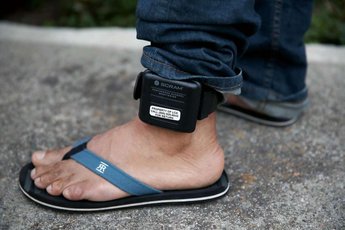 Raul Lopez, 47, wears an ankle monitor as he stands at home in Richmond, Calif., on Tuesday, September 24, 2019. Lopez, originally from Guatemala, is an undocumented immigrant who was detained by ICE for 2 years before being released in February.