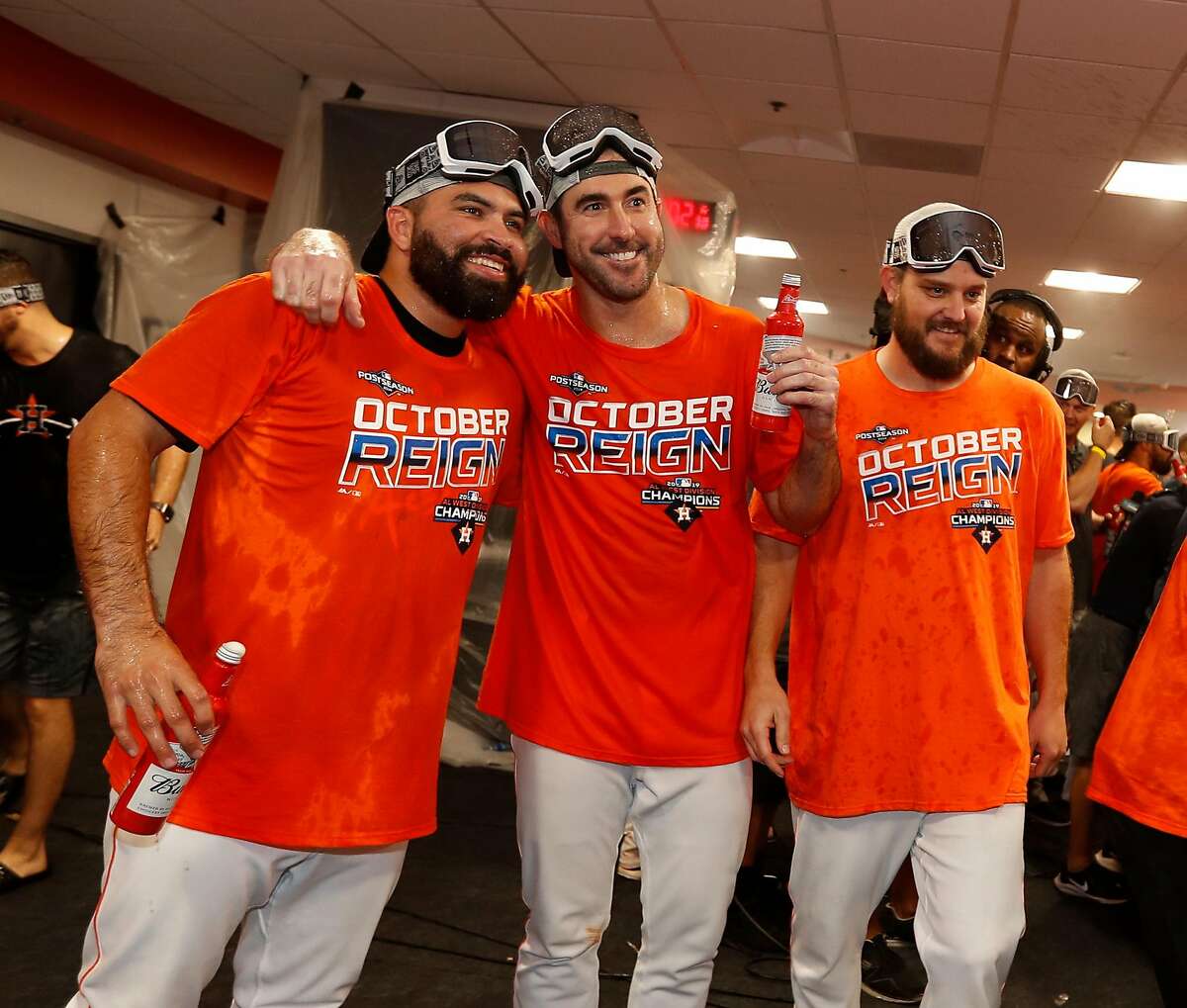Houston Astros Justin Verlander and Jose Urquidy take a photo as the team celebrated the team's win and clinching the AL West crown in the clubhouse after an MLB baseball game at Minute Maid Park, Sunday, Sept. 22, 2019, in Houston.