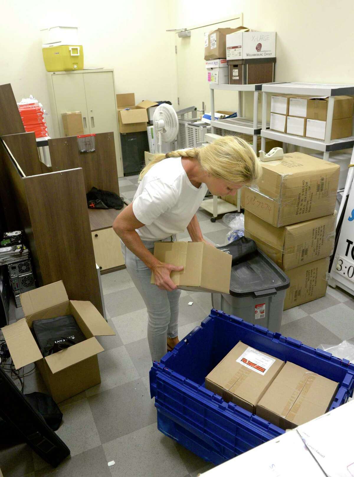 JoAnn Cueva packs up the storage room at the Greater Danbury Chamber of Commerce for their move to new office space at 1 Ives Street. Cueva is Director of Events and Business Development. Thursday, September 26, 2019, in Danbury, Conn.