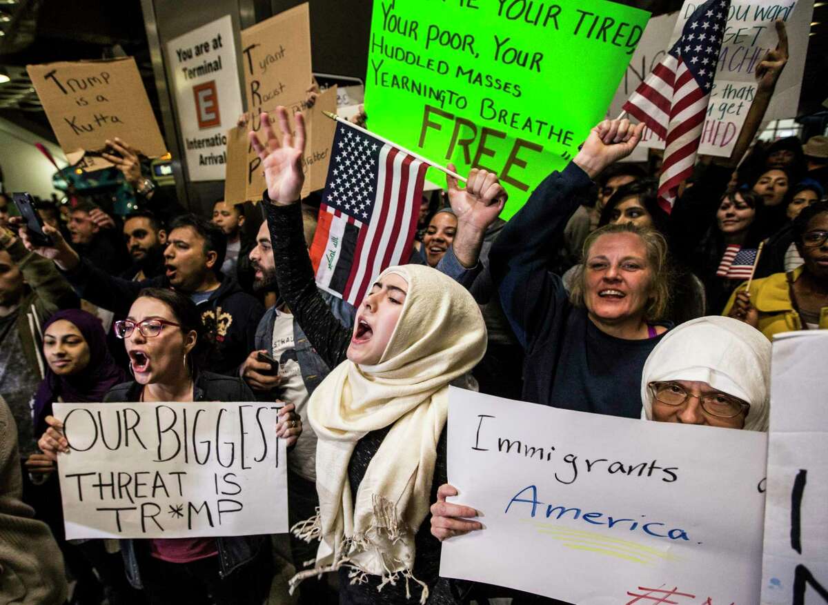 President Donald Trump this week slashed the American refugee system almost in half and required that state and local authorities publicly agree to resettle people. It is the latest move for his administration, which shortly after taking office in 2017 cut admissions and for months halted any refugees from coming. Here demonstrators protest against that executive order at George Bush Intercontinental Airport in January 2017.