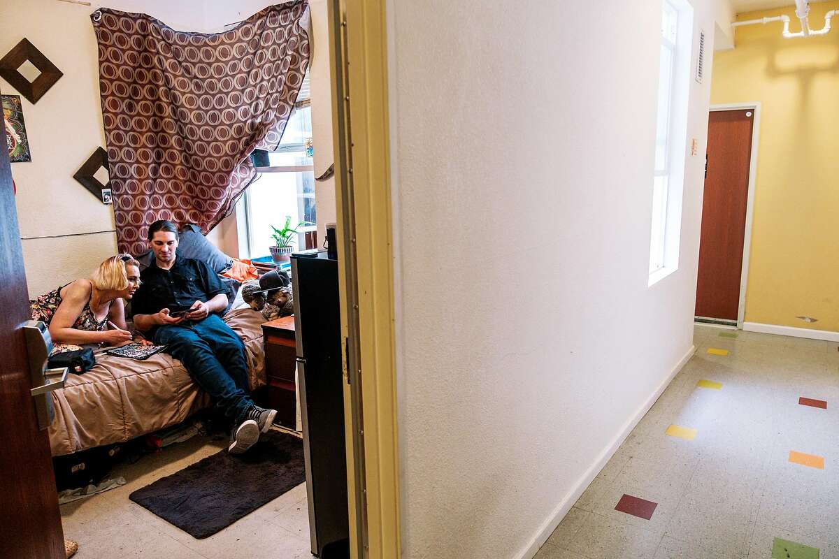 Nic Atamaniuk, a former heroin addict, and his girlfriend Natalie Notaro are seen inside his room at the Mina Lee SRO. Alarmed at the spike in fentanyl overdose deaths, San Francisco's Public Health Dept. is creating an OD prevention program for the city's vast network of gritty SRO (single-room occupancy) buildings that will train residents and managers on how to best stop people from dying from the drug. The city is on pace to nearly double the number of fentanyl overdose deaths, and with 30 percent of such ODs coming in SROs, the health department decided to lean in hard with state and federal funding, on Sept. 6 in San Francisco, Calif. on Friday, September 27, 2019.