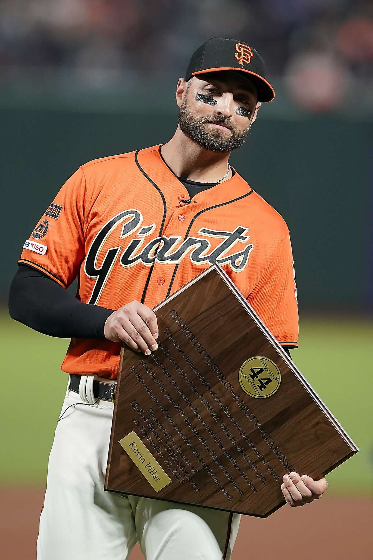 San Francisco Giants center fielder Kevin Pillar, holds the Willie Mac Award in a ceremony before a baseball game against the Los Angeles Dodgers in San Francisco, Friday, Sept. 27, 2019. The Willie Mac award is presented to the player on the Giants who best exemplifies the spirit and leadership consistently shown by Willie McCovey throughout his long career. (AP Photo/Tony Avelar)