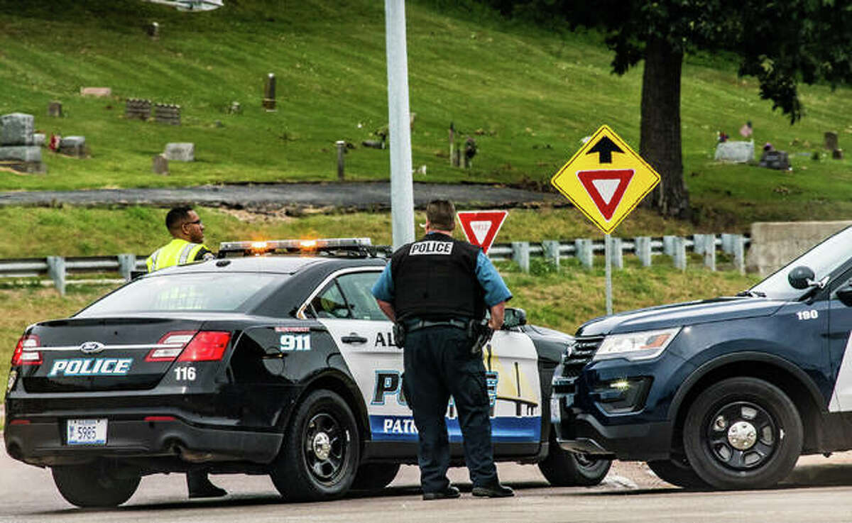 Alton police officers close the northbound lanes of the Homer Adams Parkway extension at East Broadway Saturday while investigators process the scene of a fatal motorcycle crash.