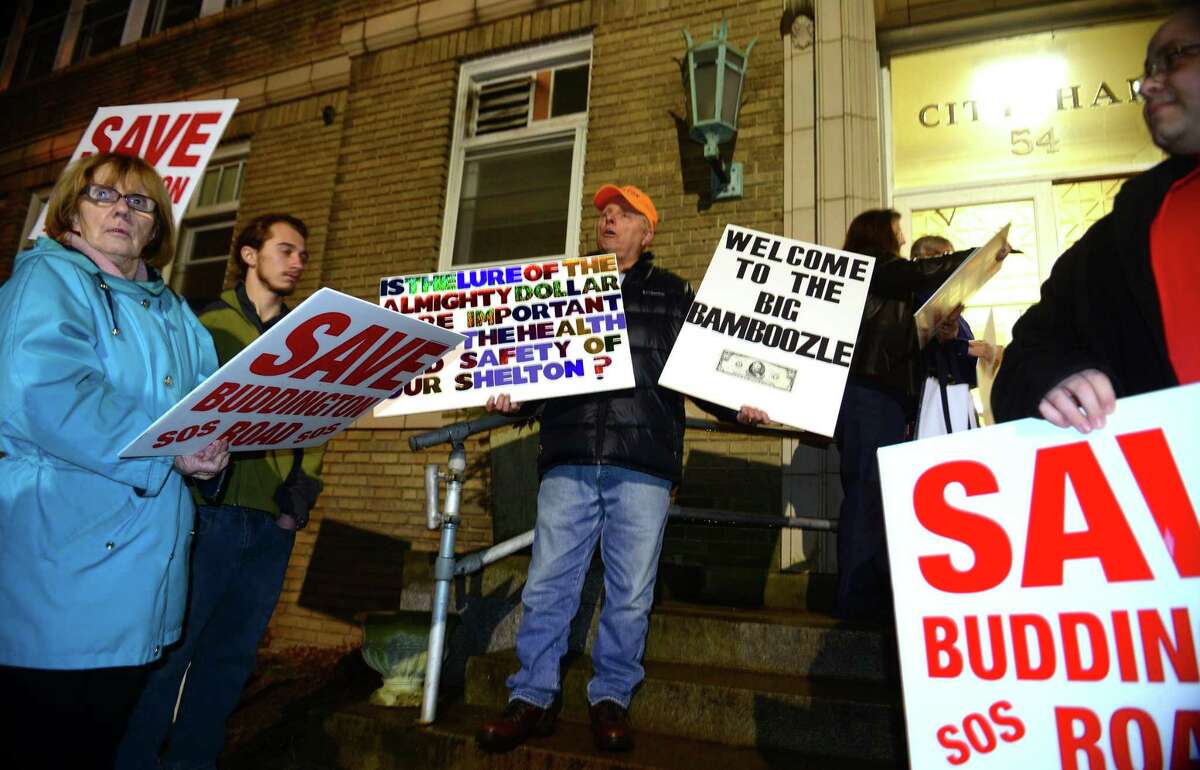 Resident Jim Jansson, center, stands with other members of Save Our Shelton outside before attending the Shelton Planning and Zoning commission meeting at Shelton City Hall in Shelton on Friday May 6, 2016. The commission did approve the request for a Planned Development District for the site. The same plans have now been pulled from the Inland Wetlands Commission.