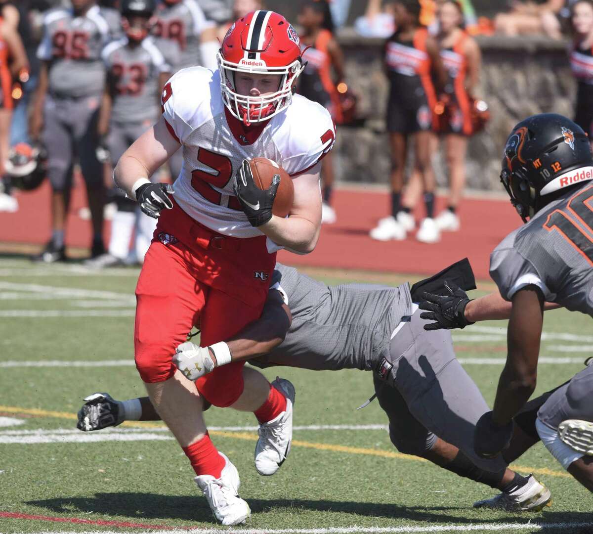 New Canaan's John Wise (29) evades a tackle on the way to one of his four touchdowns during a football game between New Canaan and Stamford at Boyle Stadium in Stamford on Saturday, Sept. 28, 2019.