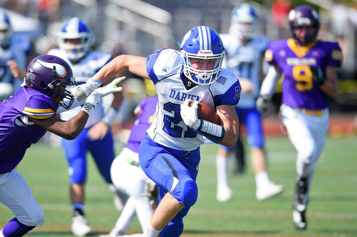 Darien's Will Kirby (21) breaks upfield in an FCIAC football game against Westhill at Westhill High School's J. Walter Kennedy Stadium on Sept. 28, 2019 in Stamford, Connecticut.