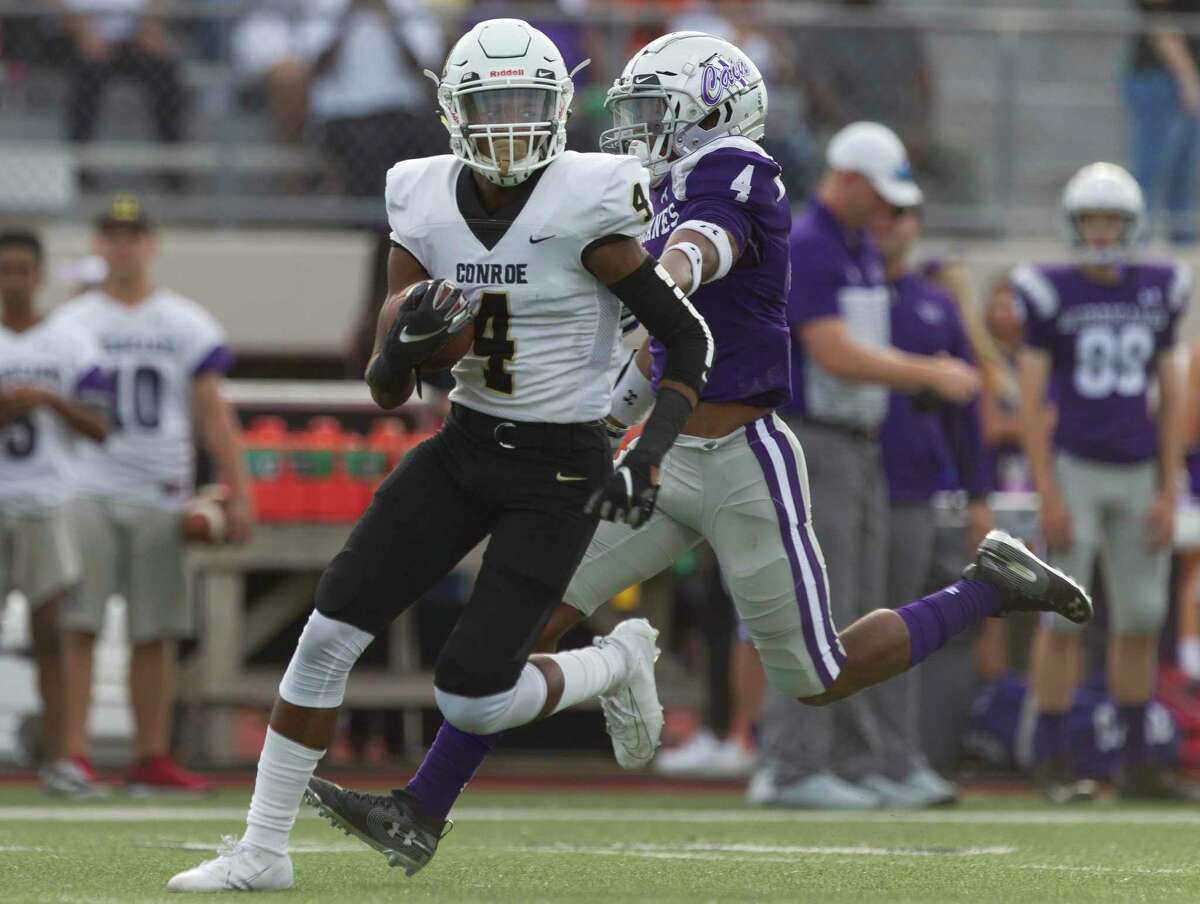 Conroe wide receiver Michael Phoenix (4) runs after catching a pass from quarterback Christian Pack for a 75-yard touchdown during the first quarter of a District 15-6A high school football game at Klein Memorial Stadium, Saturday, Sept. 28, 2019, in Spring.