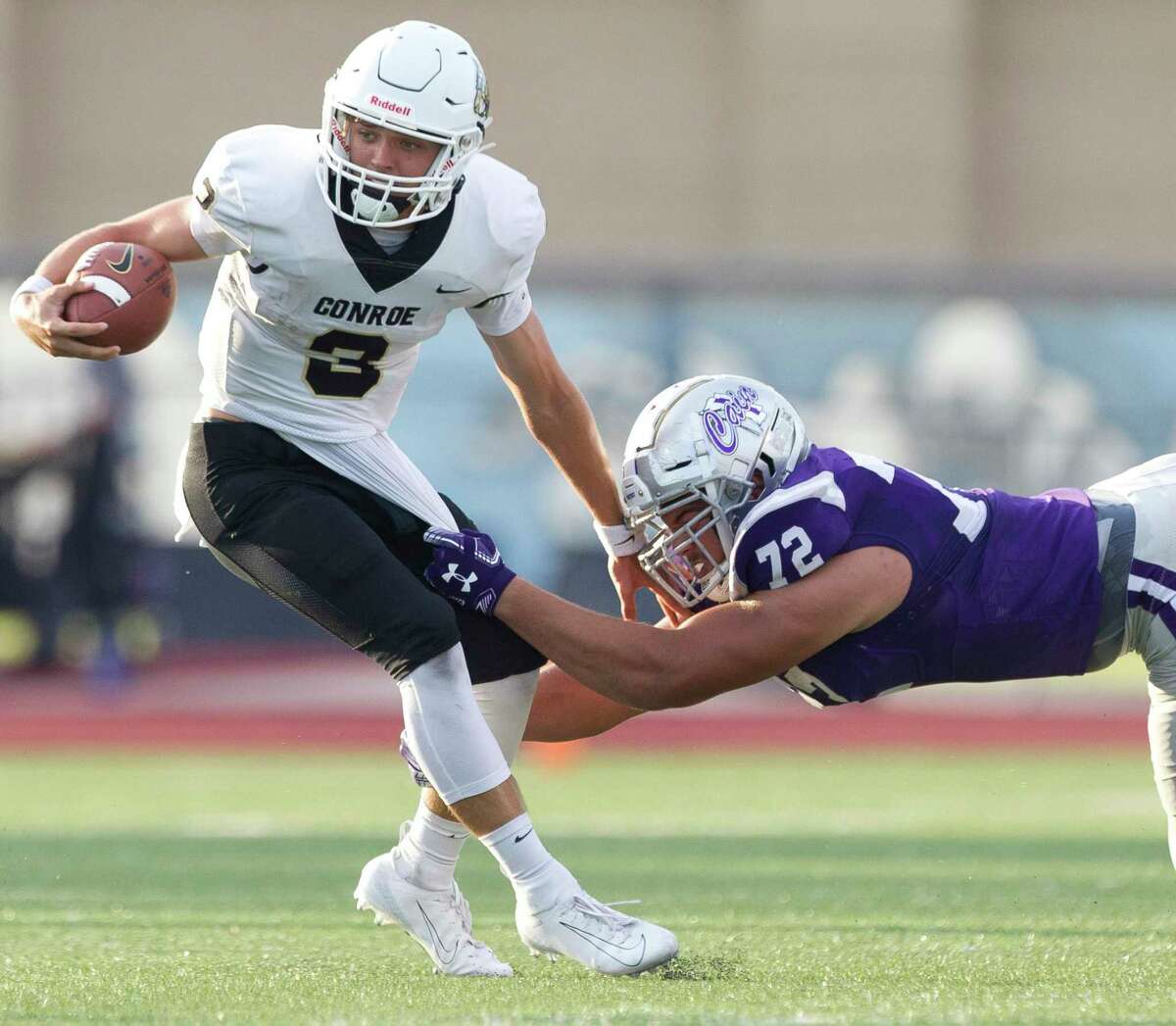 Conroe quarterback Christian Pack (3) is tackled by Klein Cain defensive linemen Brayden Espinoza (72) during the first quarter of a District 15-6A high school football game at Klein Memorial Stadium, Saturday, Sept. 28, 2019, in Spring.