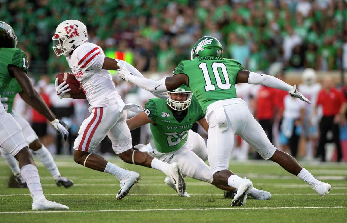 PHOTOS: UH vs. UConn  Houston’s Bryson Smith, left, leaves North Texas’ Makyle Sanders (10) and Nate Durham behind on a 60-yard punt return for a touchdown early in the fourth quarter of Saturday’s game. >>>Look back at photos from the Cougars' win Saturday ... 