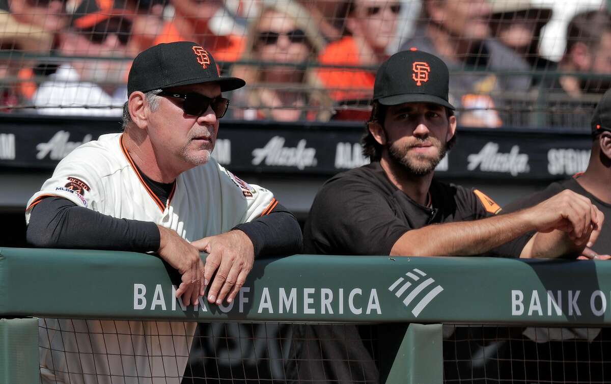 Giants manager Bruce Bochy in the dugout with pitcher Madison Bumgarner (40) in the fourth inning as he managed his final game with the San Francisco Giants at Oracle Park in San Francisco, Calif., on Sunday, September 29, 2019.