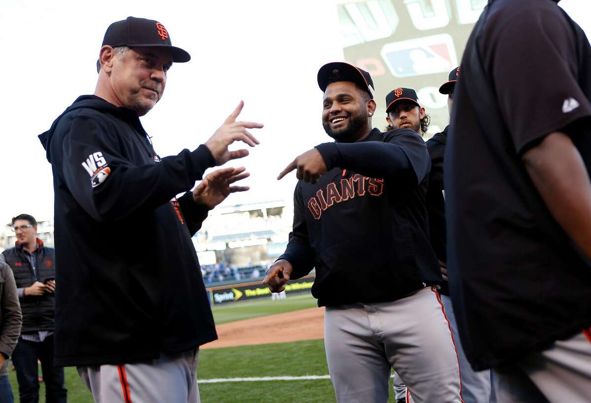 San Francisco Giants' manager Bruce Bochy and Pablo Sandoval joke before the Giants play the Kansas City Royals in Game 6 of the World Series at Kauffman Stadium in Kansas City, Missouri. on Tuesday, October 28, 2014.