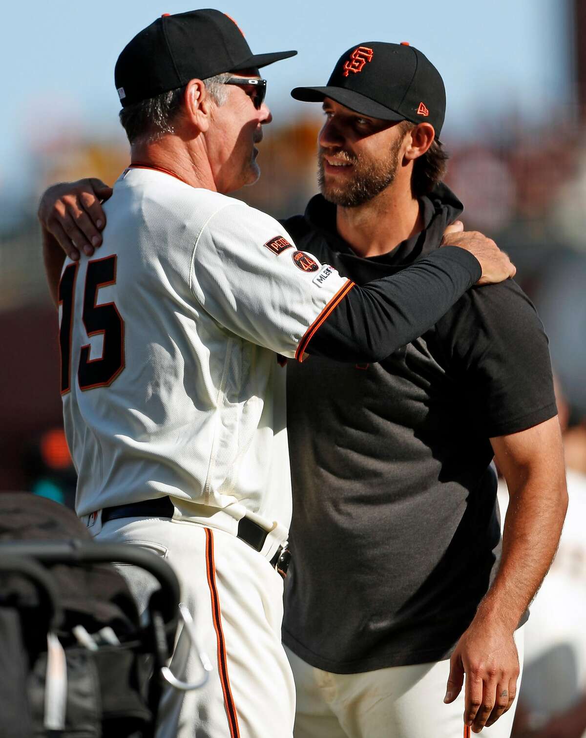 San Francisco Giants' Madison Bumgarner embraces Bruce Bochy as Bochy is honored after final game as manager of Giants at Oracle Park in San Francisco, Calif., on Sunday, September 29, 2019.