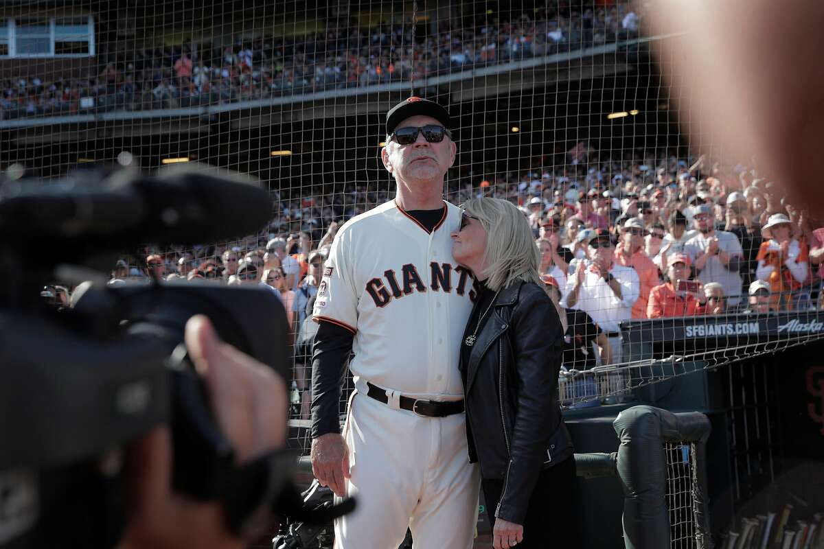 Giants manager Bruce Bochy waits outside the dugout with his wife Kim Bochy for a ceremony honoring him after he managed his final game with the San Francisco Giants at Oracle Park in San Francisco, Calif., on Sunday, September 29, 2019.