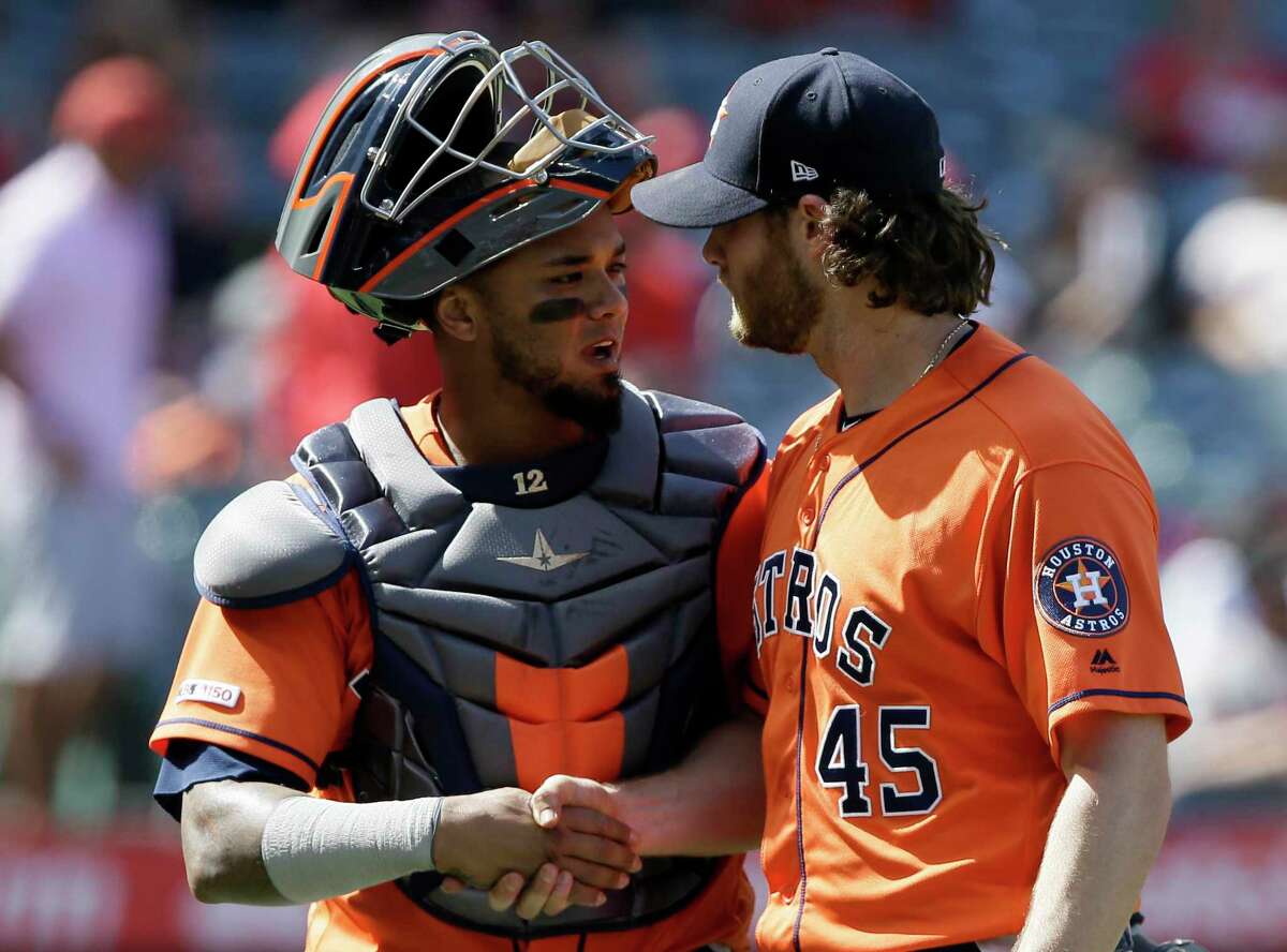 Astros catcher Martin Maldonado, left, congratulates Gerrit Cole after the pitcher ended Sunday’s fifth inning with his 10th strikeout of the game.