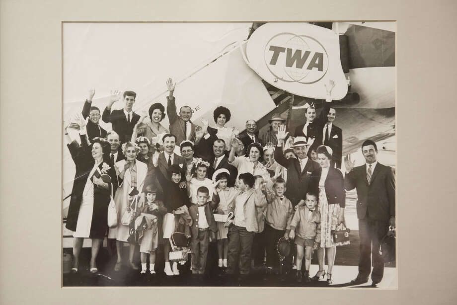 An older image with several families posing together, dressed up, to take a Fugazi-booked charter plane to Italy. Photo: Blair Heagerty / SFGate