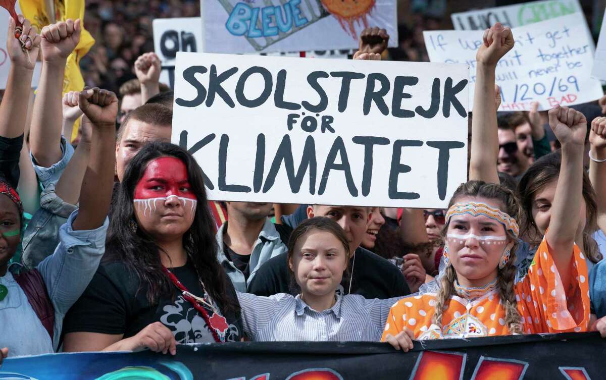 Swedish activist and student Greta Thunberg, centre, takes part in the Climate Strike in Montreal on Friday, Sept. 27, 2019. (Paul Chiasson/The Canadian Press via AP)