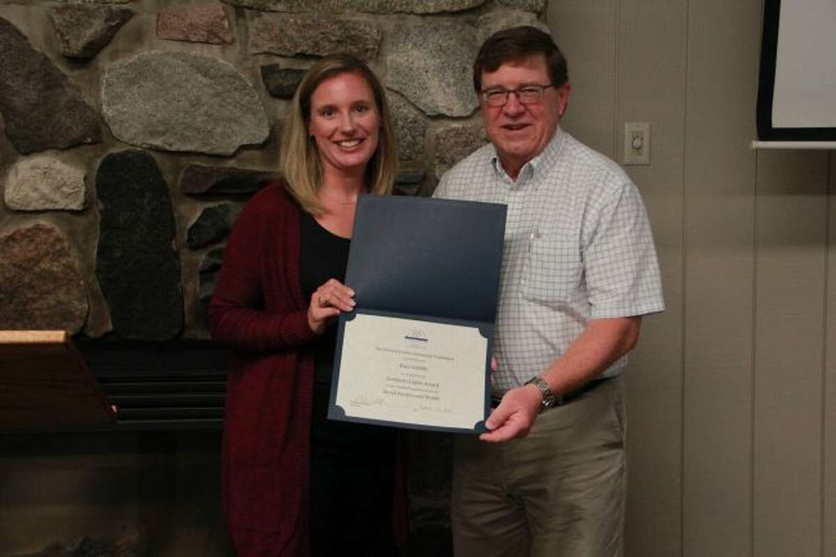 Laura Rhoades awarded Paul Griffith, on behalf of the Mecosta County Community Foundation, for his outstanding achievements in Social Services and Health. (Pioneer photo/Alicia Jaimes)