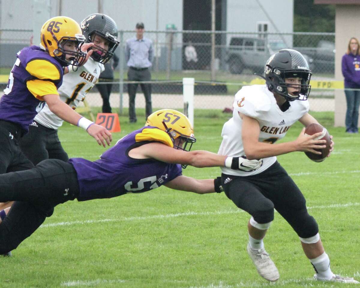 Tucker Hubbard makes a diving play to haul the Glen Lake ball carrier down at the line of scrimmage in 2019. (File photo)