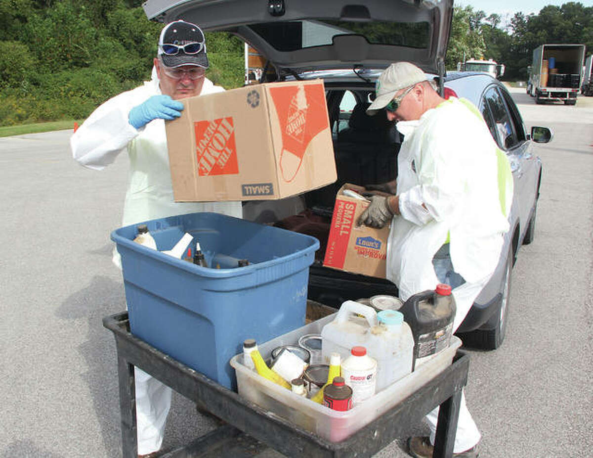 Employees of Wood River-based Heritage Environmental Services unload hazardous household waste during a collection Saturday at the Godfrey ball fields on Stamper Lane. Workers processed more than 350 loads of chemicals, ranging from oil-based paints to weed-killers during the event sponsored by Madison County Planning & Development.