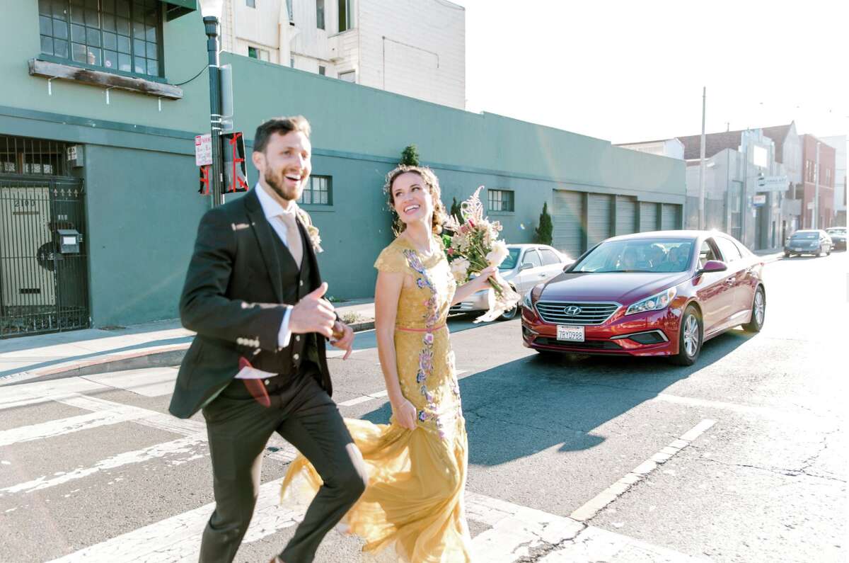 Newlyweds Zach and Sarah Rosenberg pose for photos in downtown San Francisco.