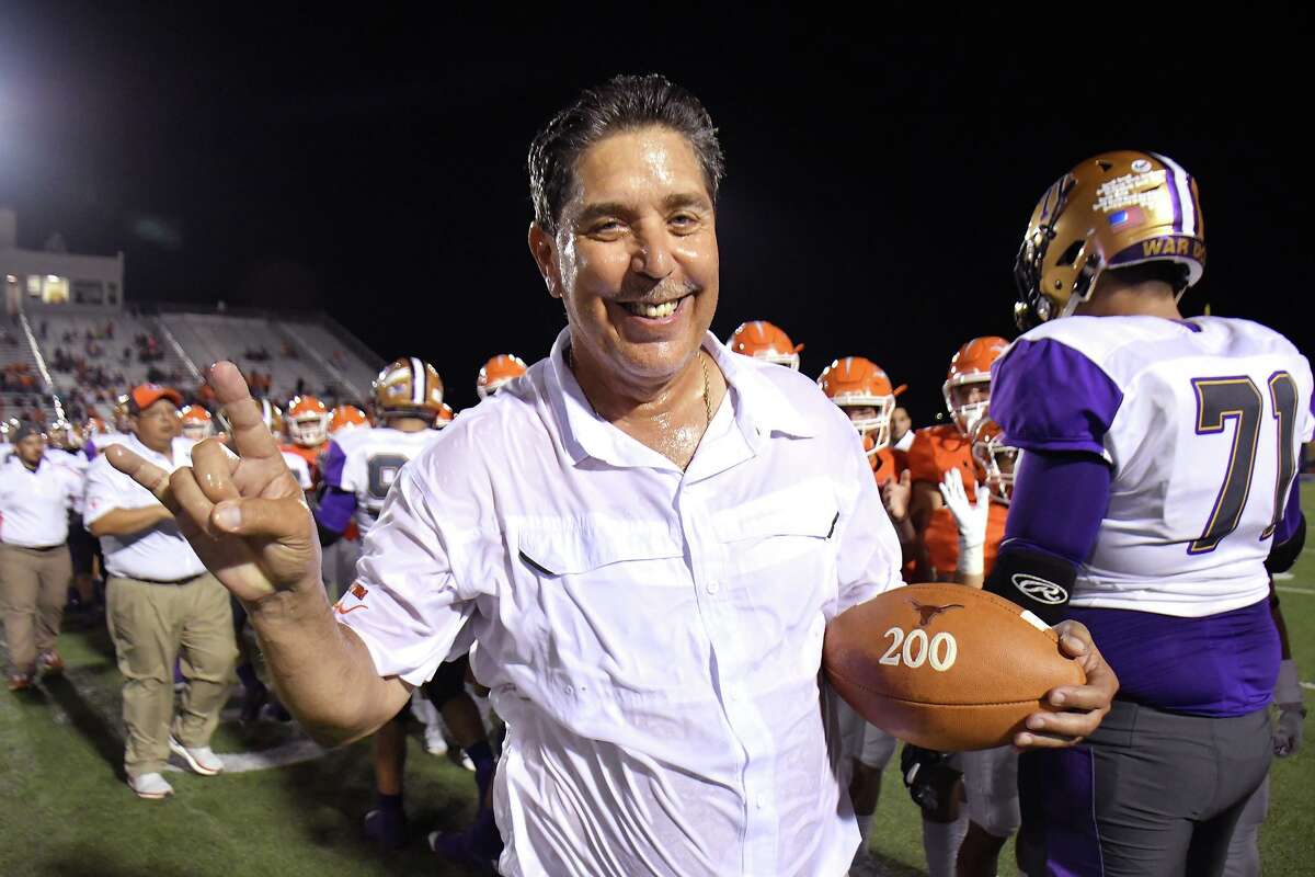 United head coach David Sanchez celebrates with a football commemorating his 200th victory Saturday at the SAC.