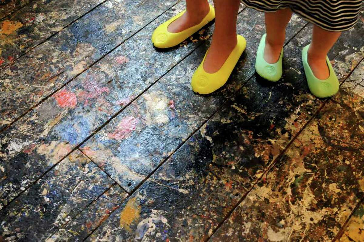 Foot coverings protect the floor during a tour of Jackson Pollock's paint-splattered studio at the Pollock-Krasner House and Study Center in East Hampton. (Michael P. Farrell / Times Union)