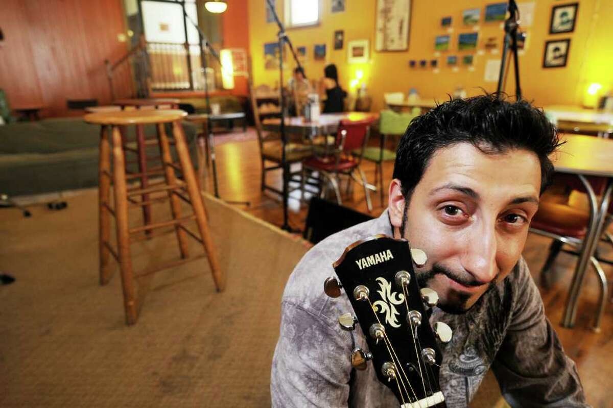 Sal Prizio, owner of Bread and Jam Cafe on Remsen St. on Monday, August 2, 2010, in Cohoes, NY. This is Sal with his guitar, used for among other things, to play when he hosts the cafe's open mic nights on Thursdays. (Luanne M. Ferris/Times Union)