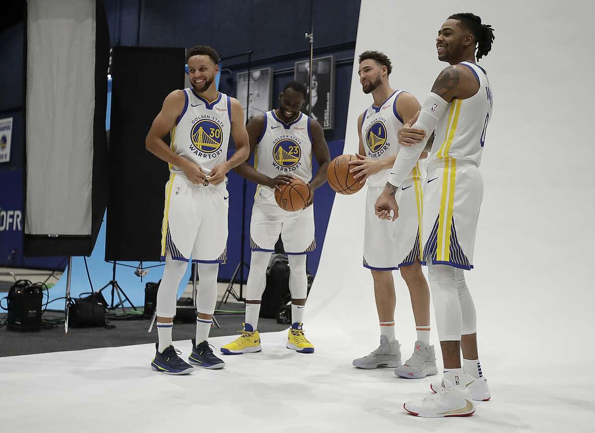 From left to right, Golden State Warriors' Stephen Curry, Draymond Green, Klay Thompson and D'Angelo Russell prepare for a photo shoot during the NBA basketball team's media day in San Francisco Monday, Sept. 30, 2019. (AP Photo/Ben Margot)