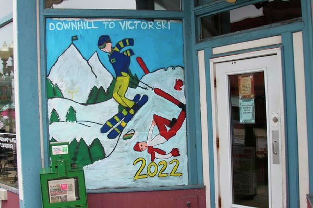 Junior class members took to the slopes for the mural that they created for the window of Goodies Juice and Java. The bonfire will take place on Friday behind Chippewa Field. (Ken Grabowski/News Advocate)