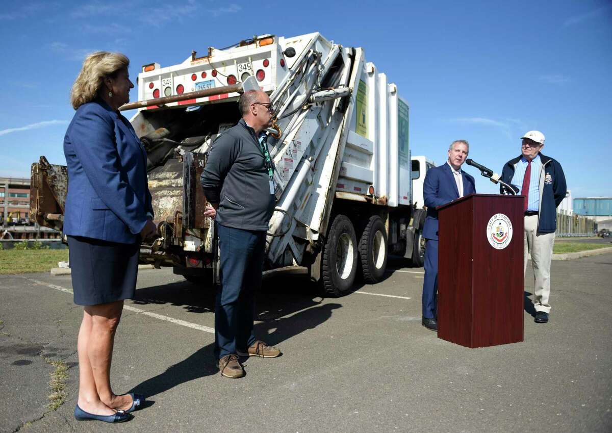 EPA Regional Administrator Dennis Diesel speaks at the podium beside DEEP Bureau Chief Tracy Babbidge, left, Supervisor of Solid Waste and Recycling Dan Colleluori, second from left, and Stamford Mayor David Martin about the city's new garbage trucks at the Stamford Transfer Station in Stamford, Conn. Monday, Sept. 30, 2019. The city will soon replace seven diesel-engine garbage trucks with new trucks that meet 2019 EPA emissions standards, costing around $2 million minus a $546,610 reimbursement from the Environmental Protection Agency.