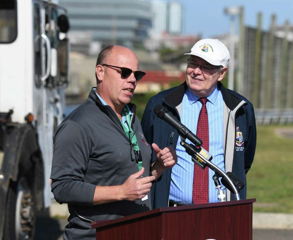 Supervisor of Solid Waste and Recycling Dan Colleluori, president of the Stamford Municipal Supervisory Employees Union, speaks beside Stamford Mayor David Martin about the city's new garbage trucks at the Stamford Transfer Station in Stamford, Conn. Monday, Sept. 30, 2019.