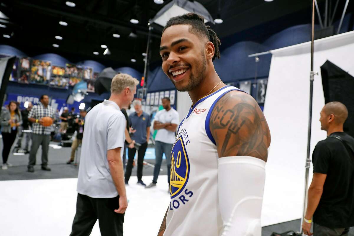 Golden State Warriors' D'Angelo Russell smiles after talking with head coach Steve Kerr during media day at Chase Center in San Francisco, Calif., on Monday, September 30, 2019.