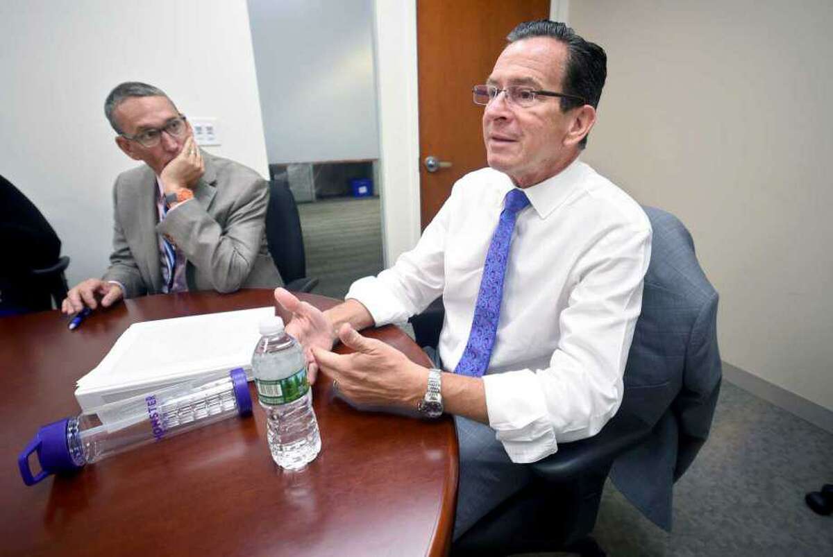 Former Gov. Dannel Malloy is shown with his budget chief, Ben Barnes.