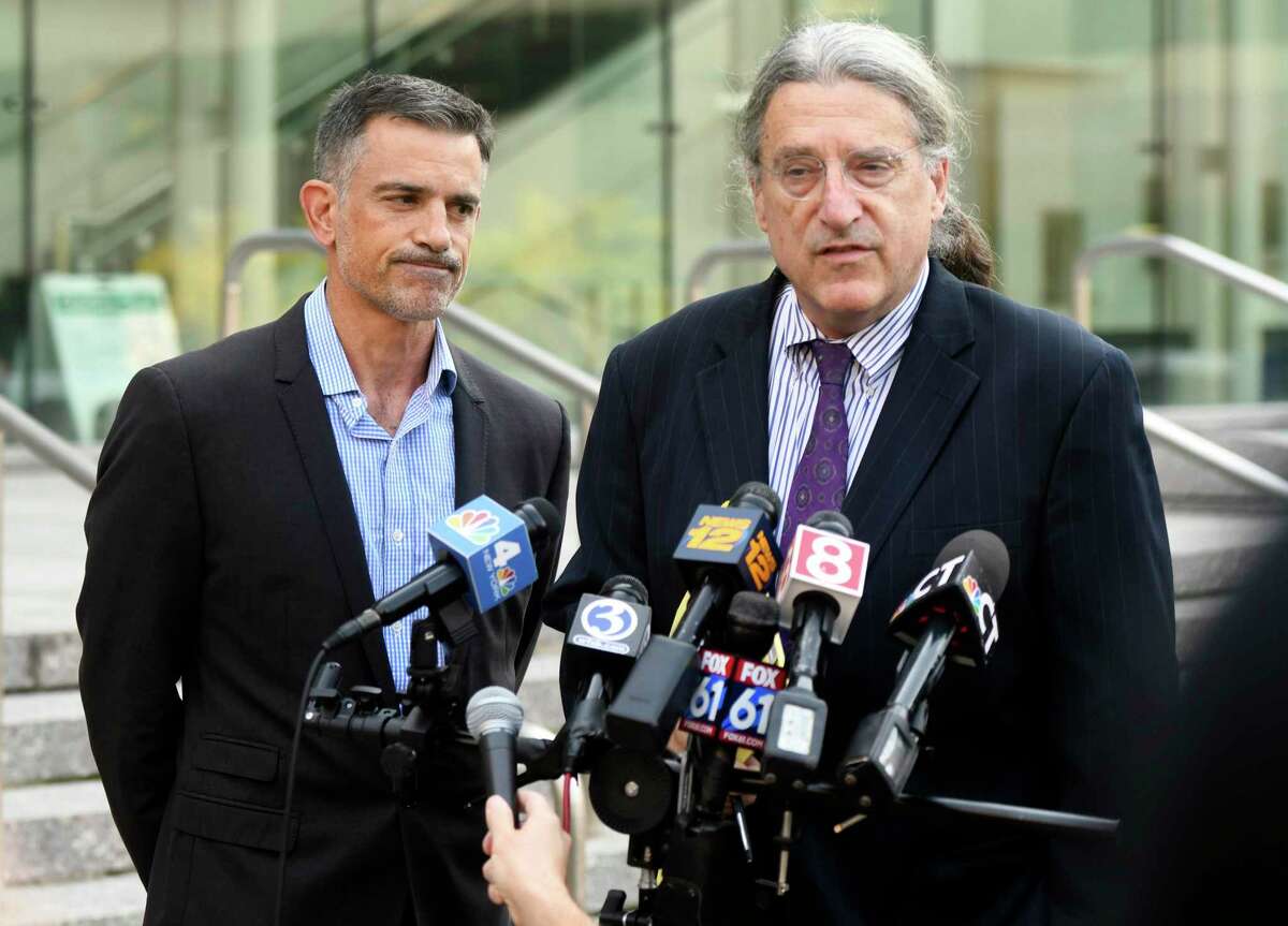 Fotis Dulos, left, listens as his attorney Norm Pattis addresses the media after appearing at the Connecticut Superior Court in Stamford, Conn., Monday, Sept. 23, 2019.