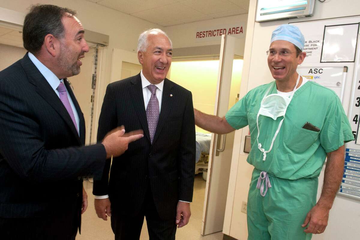 SEPTEMBER — Hospital mergers continie as Hartford HealthCare takes over St. Vincent’s Medical Center in Bridgeport. St. Vincent CEO Vincent DiBattista, center, is shown alongside Hartford HealthCare CEO Jeffrey Flaks (left) and Dr. Rafael Squitieri, chief of cardiothoracic surgery.