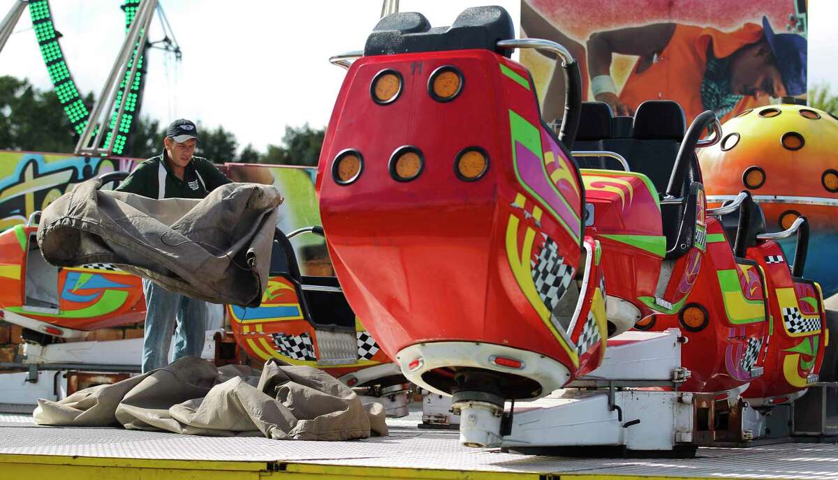Workers setup carnival rides in preparation for this weekend's annual Conroe Cajun Catfish Festival, Wednesday, Oct. 10, 2018, in downtown Conroe. The event runs Oct. 12 - 14 with admission for children under 12 free and general admission is $15 at the gate.