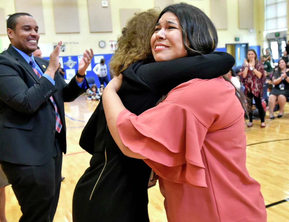 Clinton Avenue School teacher Lauren Sepulveda, right, hugs Jane Foley, senior vice-president of the Milken Family Foundation Milken Educator Awards, after she was surprised by an announcement during an assembly at the school Tuesday that she was given a Milkin Educator Award of $25,000 for being an exceptional teacher.